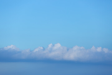 Blue sky background with tiny clouds.