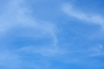 Blue sky background with tiny clouds.