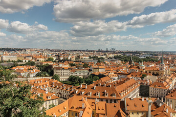 Naklejka na ściany i meble Amazing European cityscape.Aerial view of old town with hictorical buildings,red roofs,churches,skyscrapers in Prague,Czechia.Prague panorama.Beautiful sunny landscape of the capital of Czechia.