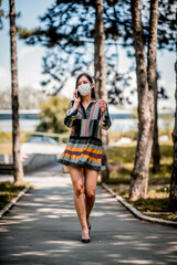 Fashionable woman wearing protective face mask  during pandemic