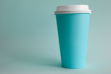 There is turquoise glass of coffee on table. Fast contactless beverage delivery concept