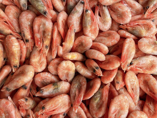 Raw unpeeled shrimp frozen. Showcase in the supermarket.