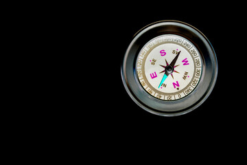 abstract round compass on black background as symbol of tourism with compass, travel with compass and outdoor activities with compass