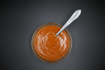 Traditional mexican homemade salsa sauce in a glass bowl and a b. salsa roja con fondo negro