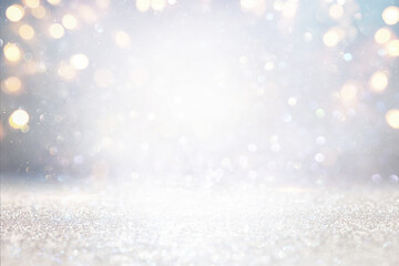 glitter vintage lights background. silver, gold and white. de-focused