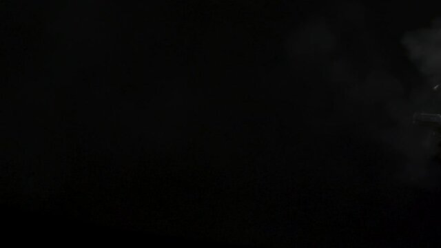 45 muzzle flashes continue fire montage in slow-motion. Dangerous shooting against black screen muzzle flashes in slow-motion.