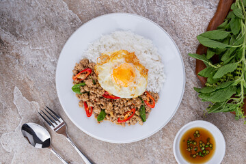 rice topped with stir-fried mince pork and basil with fried egg , Thai famous Street food