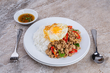 rice topped with stir-fried mince pork and basil with fried egg , Thai famous Street food