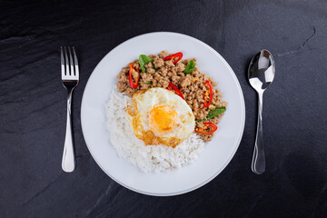 rice topped with stir-fried mince pork and basil with fried egg , Thai famous Street food