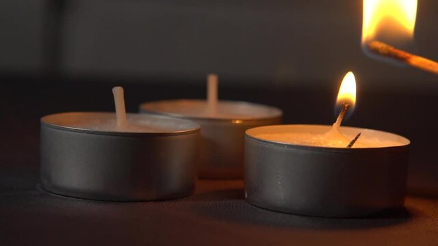 Lighting up two tealights with a match