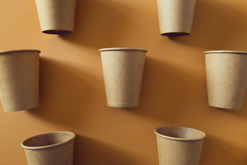 Eco friendly craft paper cups on colorful background. Recycling concept.