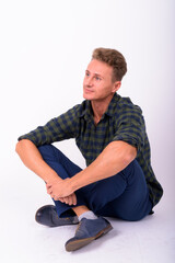 Handsome man with blond curly hair against white background