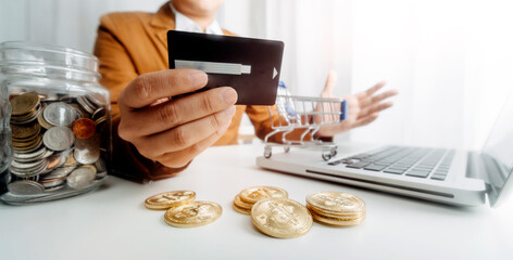 Business people use tablets and hold credit cards as an online shopping concept With a calculator and a book placed on the table