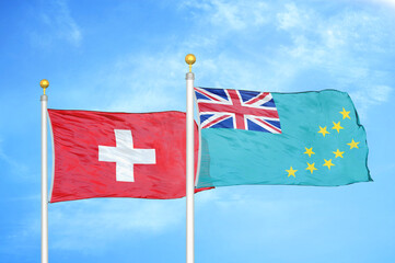 Switzerland and Tuvalu two flags on flagpoles and blue sky