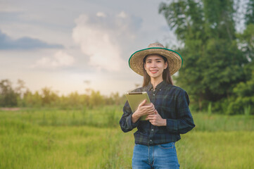 Asian women using tablet checking smart farmer in farm smart technology