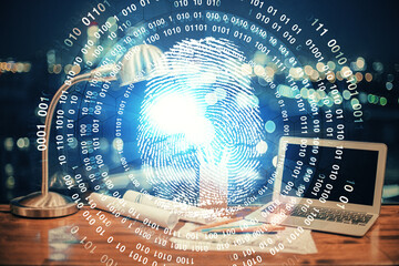 Computer on desktop in office with finger print drawing. Double exposure. Concept of business data security.