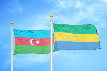 Azerbaijan and Gabon two flags on flagpoles and blue sky