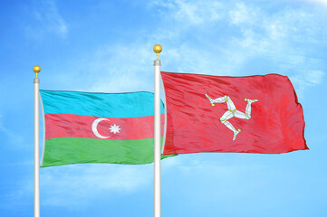 Azerbaijan and Isle of Mann two flags on flagpoles and blue sky