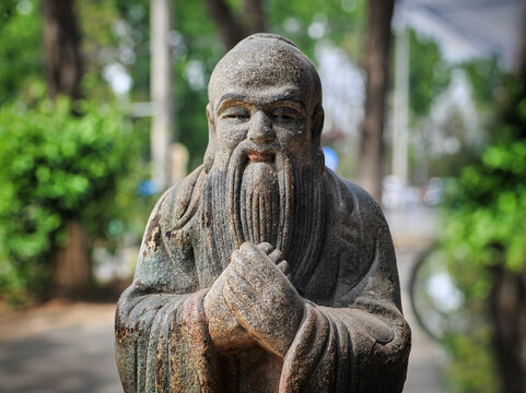 A statue of a Chinese monk who is always depicted laughing with a protruding belly.