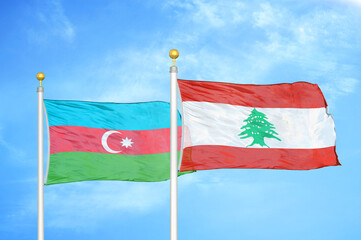 Azerbaijan and Lebanon two flags on flagpoles and blue sky