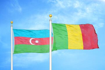 Azerbaijan and Mali two flags on flagpoles and blue sky