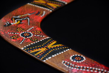 Australian hand painted boomerang detail stock images. Boomerang isolated on a black background...