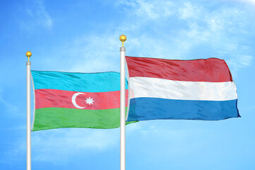 Azerbaijan and Netherlands two flags on flagpoles and blue sky