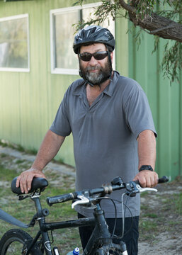 Middle-aged man with bicycle and helmet