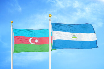 Azerbaijan and Nicaragua two flags on flagpoles and blue sky