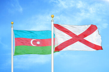 Azerbaijan and Northern Ireland two flags on flagpoles and blue sky