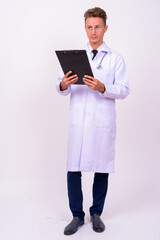 Handsome man doctor with blond curly hair against white background