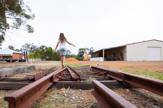child walking along old disused railway track