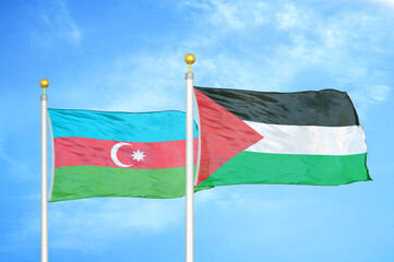 Azerbaijan and Palestine two flags on flagpoles and blue sky
