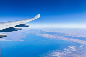 Aeroplane wing and view over coastal land in SA
