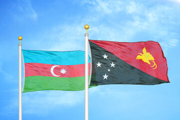 Azerbaijan and Papua New Guinea two flags on flagpoles and blue sky