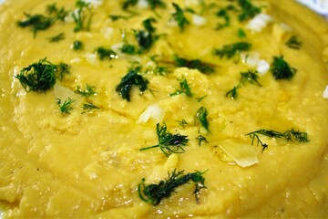Traditional Greek Fava, yellow split pea puree with olive oil, onion and dill.