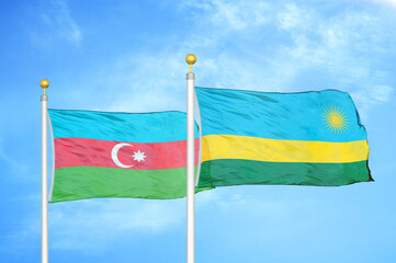 Azerbaijan and Rwanda two flags on flagpoles and blue sky