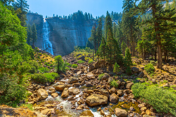 bottom view of Nevada Fall waterfall from Mist Trail in Yosemite National Park. Summer travel...