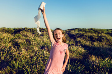 funny tween girl holding toilet paper in the air like an olympic torch