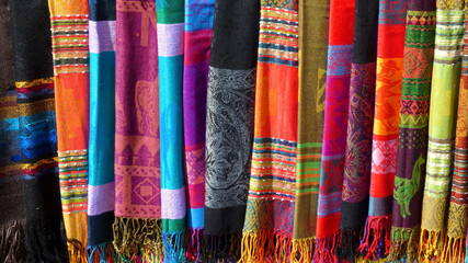 Colorful scarves with andean pattern on the display at the market in Cuenca, Ecuador