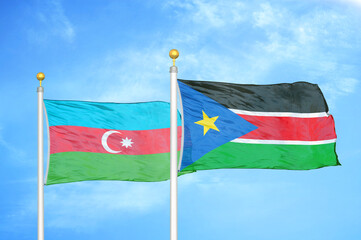 Azerbaijan and South Sudan two flags on flagpoles and blue sky