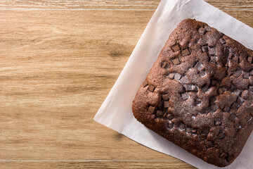 Sweet chocolate sponge cake on wooden table. Top view. Copy space	