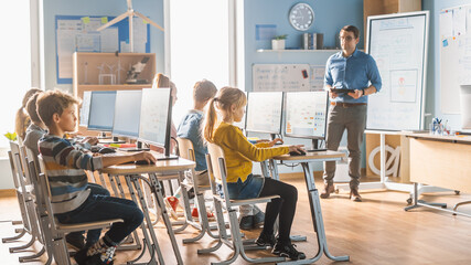 Elementary School Science Classroom: Teacher Educates Smart Little Schoolchildren who Work on...
