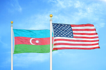 Azerbaijan and United States two flags on flagpoles and blue sky