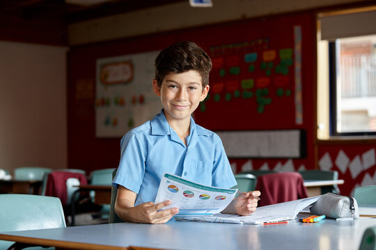 Primary school student in classroom working on homework