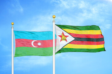 Azerbaijan and Zimbabwe two flags on flagpoles and blue sky