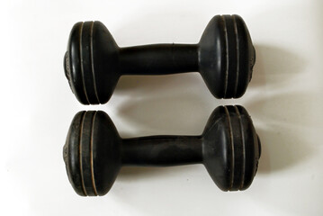 Obraz na płótnie Canvas A pair of black workout dumbbells isolated on white background..