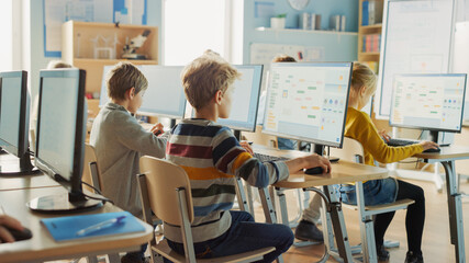 Elementary School Computer Science Classroom: Smart Little Schoolchildren Work on Personal...