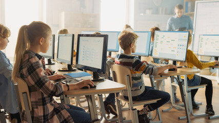 Elementary School Computer Science Classroom: Smart Little Schoolchildren Work on Personal Computers, Learn Programming Language for Software Coding. Schoolchildren Getting Modern Education
