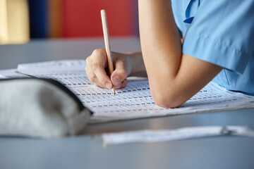 Primary school student in classroom working on homework